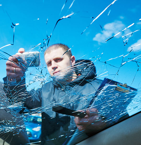 Insurance agent recording car damage on claim form Insurance agent recording car damage on claim form